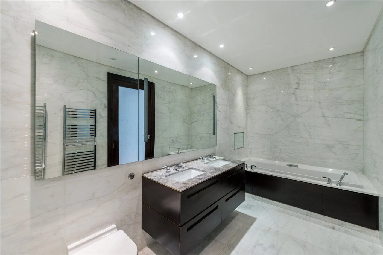 St John's Wood apartment bathroom with marble walls and a vanity