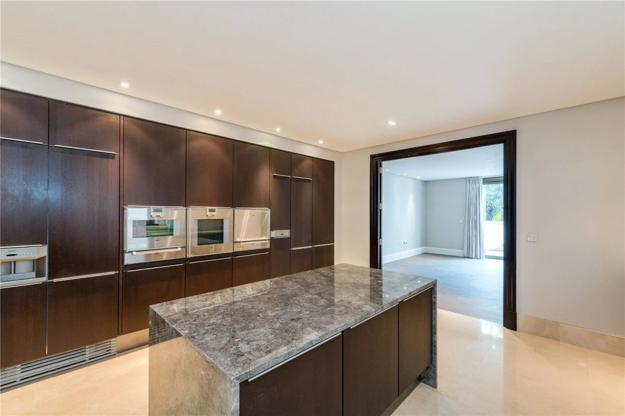 St John's Wood apartment kitchen with dark cabinetry and a central island